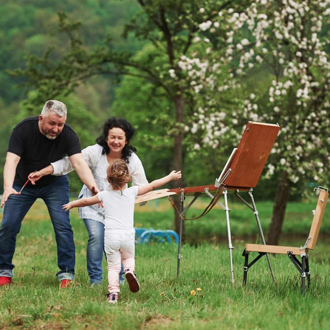 Give me embrace. Grandmother and grandfather have fun outdoors with granddaughter. Painting conception.